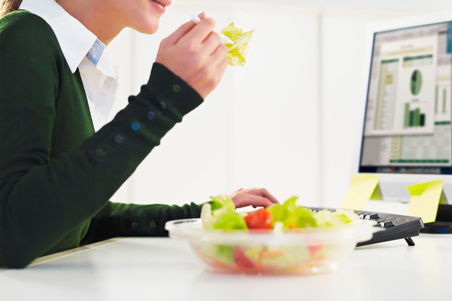 Woman Eating A Salad At Desk